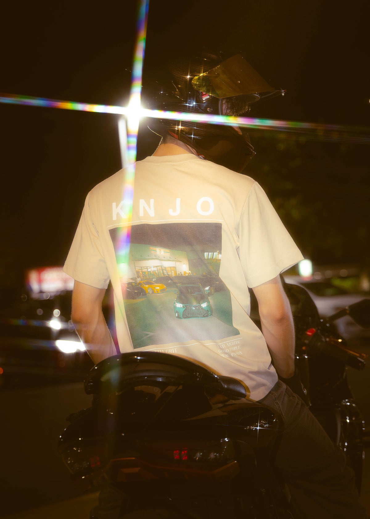 KNJO automotive streetwear T-shirt worn at a nighttime car meet